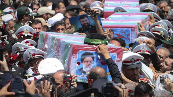 In this photo released by the Iranian Presidency Office, flag-draped coffins of the President Ebrahim Raisi and his companions who were killed in a helicopter crash on Sunday, are carried during their funeral ceremony in the city of Mashhad, Iran, Thursday, May 23, 2024. Iran on Thursday prepared to inter its late president at the holiest site for Shiite Muslims in the Islamic Republic, a final sign of respect for a protégé of Iran's supreme leader killed in a helicopter crash earlier this week. (Iranian Presidency Office via AP)