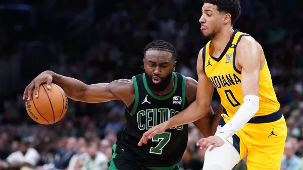 May 23, 2024; Boston, Massachusetts, USA; Boston Celtics guard Jaylen Brown (7) dribbles the ball against Indiana Pacers guard Tyrese Haliburton (0) in the first half during game two of the eastern conference finals for the 2024 NBA playoffs at TD Garden. Mandatory Credit: David Butler II-USA TODAY Sports