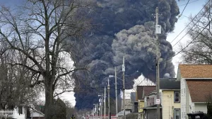 FILE - A black plume rises over East Palestine, Ohio, as a result of the controlled detonation of a portion of the derailed Norfolk Southern trains Monday, Feb. 6, 2023. A federal judge on Tuesday, May 21, 2024, has signed off on the 0 million class action settlement over last year's disastrous Norfolk Southern derailment in eastern Ohio, but many people who live near East Palestine are still wondering how much they will end up with out of the deal. (AP Photo/Gene J. Puskar, File)