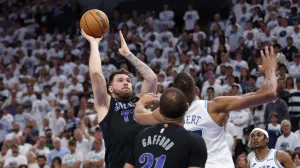 May 24, 2024; Minneapolis, Minnesota, USA; Dallas Mavericks guard Luka Doncic (77) shoots against Minnesota Timberwolves center Rudy Gobert (27) in the fourth quarter during game two of the western conference finals for the 2024 NBA playoffs at Target Center. Mandatory Credit: Jesse Johnson-USA TODAY Sports