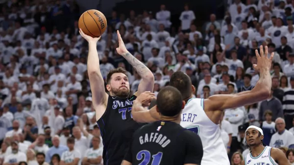 May 24, 2024; Minneapolis, Minnesota, USA; Dallas Mavericks guard Luka Doncic (77) shoots against Minnesota Timberwolves center Rudy Gobert (27) in the fourth quarter during game two of the western conference finals for the 2024 NBA playoffs at Target Center. Mandatory Credit: Jesse Johnson-USA TODAY Sports