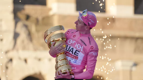 Tour of Italy winner Slovenia's Tadej Pogacar holds the trophy during the podium ceremony at the end of the 21st and last stage of the Giro D'Italia, cycling race, in Rome, Sunday, May 26, 2024. (AP Photo/Andrew Medichini)