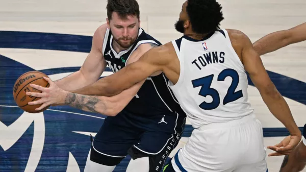 May 28, 2024; Dallas, Texas, USA; Dallas Mavericks guard Luka Doncic (77) dribbles against Minnesota Timberwolves center Karl-Anthony Towns (32) during the second quarter of game four of the western conference finals for the 2024 NBA playoffs at American Airlines Center. Mandatory Credit: Jerome Miron-USA TODAY Sports