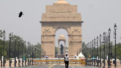 A man walks past the India Gate monument on a hot summer day in New Delhi, India, Monday, May 27, 2024. (AP Photo/Manish Swarup)