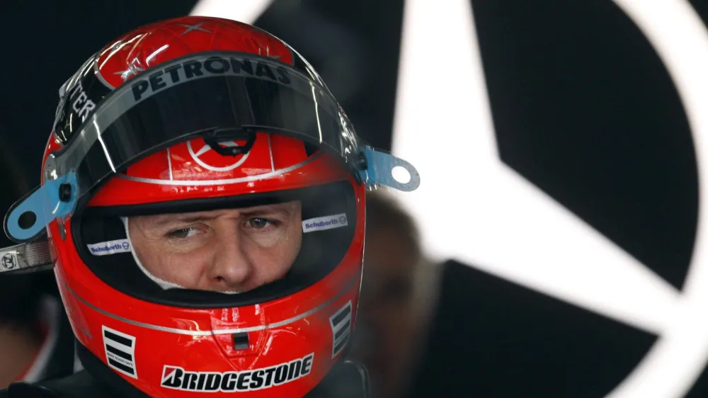 Mercedes Formula One driver Michael Schumacher of Germany stands inside his box before the third practice session of the Chinese F1 Grand Prix at Shanghai International Circuit April 17, 2010.   REUTERS/Jason Lee (CHINA - Tags: SPORT MOTOR RACING)