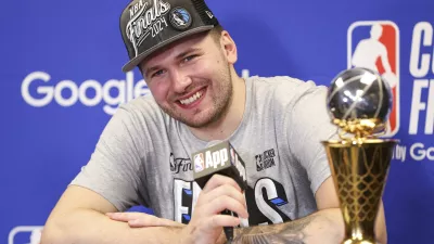 Dallas Mavericks guard Luka Doncic smiles during a news conference after the team's win over the Minnesota Timberwolves in Game 5 of the NBA basketball Western Conference finals Thursday, May 30, 2024, in Minneapolis. (AP Photo/Matt Krohn)