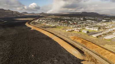 Lava flow is seen in the town of Grindavik, Iceland, Thursday, May 30, 2024. Lava continued to spurt from a volcano in southwestern Iceland on Thursday but the activity had calmed significantly from when it erupted a day earlier. (AP Photo/Marco di Marco)