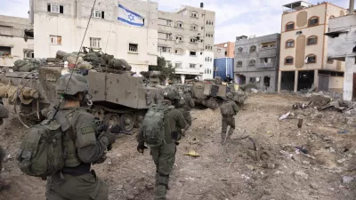 FILE - Israeli soldiers walk in Gaza City's Shijaiyah neighborhood on Dec. 8, 2023, as part of an operation to round up hundreds of Palestinians across the northern Gaza Strip and truck some to an undisclosed location. (AP Photo/Moti Milrod, Haaretz, File)