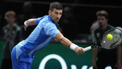 Serbia's Novak Dokovic returns the ball to Denmark's Holger Rune during their quarterfinal match of the Paris Masters tennis tournament, at the Accor Arena in Paris, Friday, Nov. 3, 2023. (AP Photo/Michel Euler)