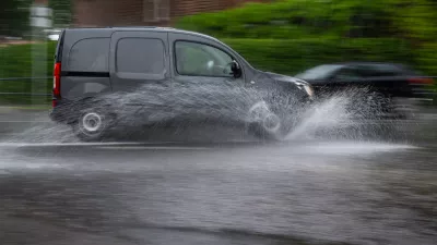 02 June 2024, Brandenburg, Reichenwalde: A car drives across a flooded intersection during a thunderstorm with heavy rain. Photo: Monika Skolimowska/dpa