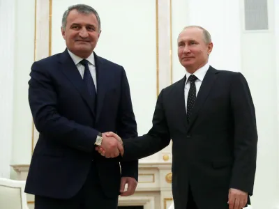 FILE PHOTO: Russian President Vladimir Putin and Anatoly Bibilov, the leader of Georgia's breakaway region of South Ossetia, shake hands during their meeting in the Kremlin in Moscow, Russia, March 6, 2019. Pavel Golovkin/Pool via REUTERS/File Photo