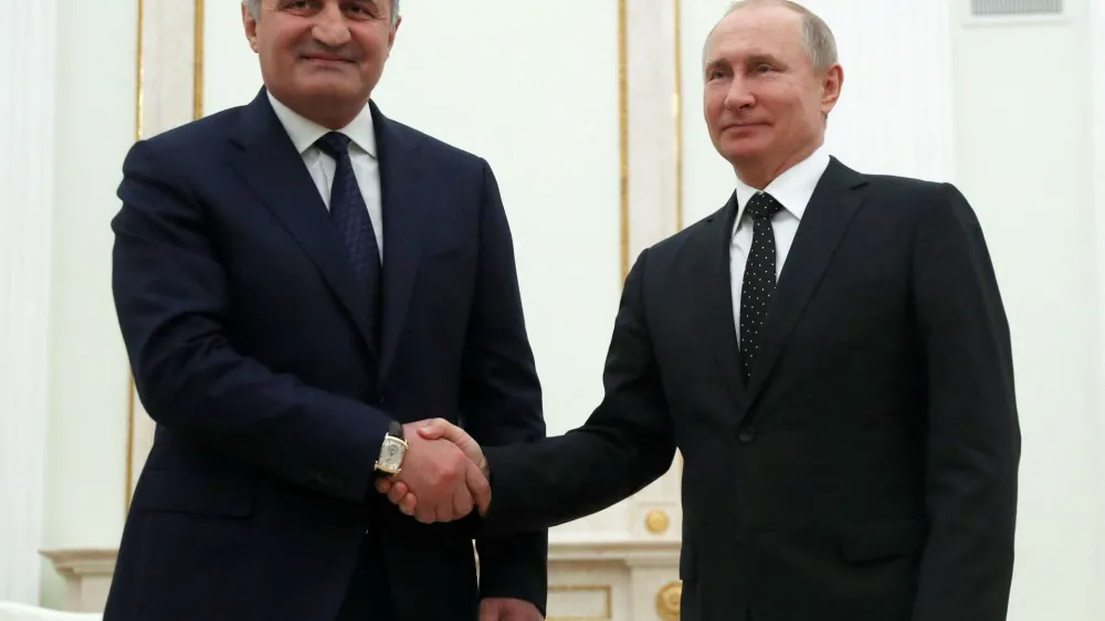 FILE PHOTO: Russian President Vladimir Putin and Anatoly Bibilov, the leader of Georgia's breakaway region of South Ossetia, shake hands during their meeting in the Kremlin in Moscow, Russia, March 6, 2019. Pavel Golovkin/Pool via REUTERS/File Photo