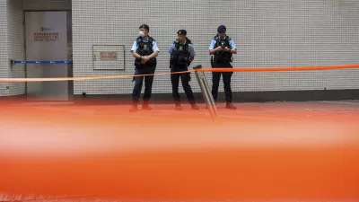 Police officers stand guard in the Causeway Bay area on the 35th anniversary of China's Tiananmen Square crackdown in Hong Kong, Tuesday, June 4, 2024. (AP Photo/Chan Long Hei)