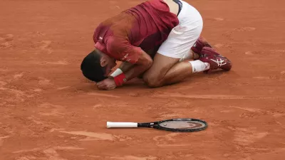 Serbia's Novak Djokovic slipped and fell during his fourth round match of the French Open tennis tournament against Argentina's Francisco Cerundolo at the Roland Garros stadium in Paris, Monday, June 3, 2024. (AP Photo/Christophe Ena)