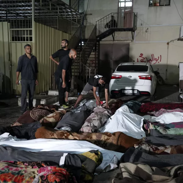 Palestinians check the bodies of their relatives killed in an Israeli bombardment of UNRWA school at Nusseirat refugee camp, in front of the morgue of al-Aqsa Martyrs hospital in Deir al-Balah, central Gaza Strip, early Thursday, June 6, 2024. (AP Photo/Abdel Kareem Hana)