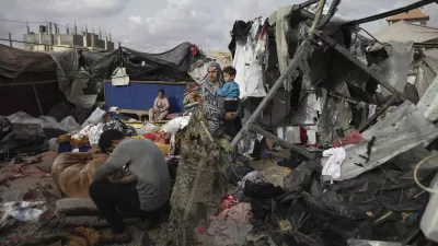 FILE - Displaced Palestinians inspect their tents destroyed by Israel's bombardment, adjunct to an UNRWA facility west of Rafah city, Gaza Strip, Tuesday, May 28, 2024. A single image, not even an authentic photograph, is the focus of a singular campaign on Instagram that has caught the attention of the algorithm and captured the imaginations of users across national borders — a show of support for the Palestinian movement as the war between Israel and Hamas enters its eighth month. (AP Photo/Jehad Alshrafi, File)