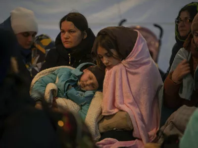 ﻿Refugees, mostly women with children, rest inside a tent after arriving at the border crossing, in Medyka, Poland on Sunday, March 6, 2022. (AP Photo/Visar Kryeziu)