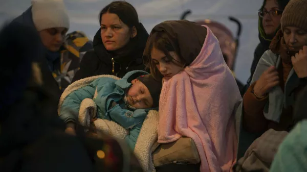 ﻿Refugees, mostly women with children, rest inside a tent after arriving at the border crossing, in Medyka, Poland on Sunday, March 6, 2022. (AP Photo/Visar Kryeziu)