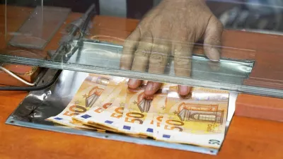 Cash money euro, at bank office or currency exchanger. Male hand with euro money in cash department window. Currency exchange concept. Clerk giving cash money to customer at bank office.