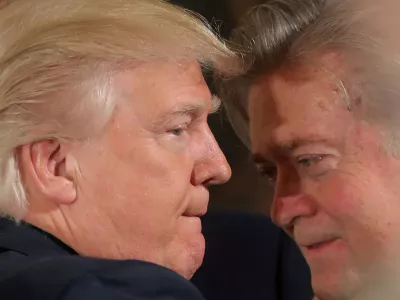 ﻿FILE PHOTO: U.S. President Donald Trump talks to chief strategist Steve Bannon during a swearing in ceremony for senior staff at the White House in Washington, U.S. January 22, 2017. REUTERS/Carlos Barria/File Photo