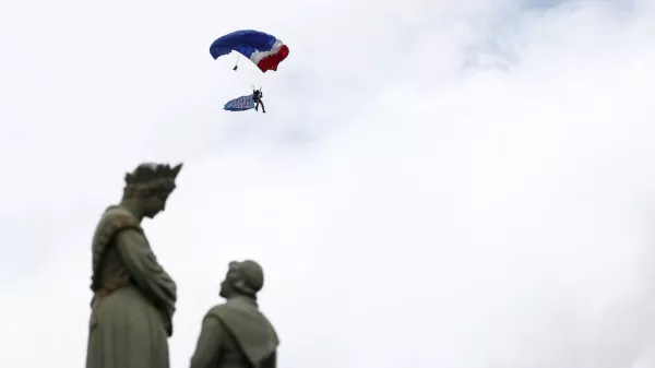 A French soldier of the 1st RPIMa Special Forces parachutes during a ceremony to pay homage to the Saint Marcel maquis, a force of French Resistance fighters during World War II and the French SAS (Special Air Service) paratroopers, in Plumelec, Brittany, on the eve of D-Day 80th anniversary landings in Normandy, Wednesday June 5, 2024. (Benoit Tessier/Pool via AP)