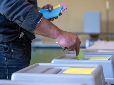 09 June 2024, Rhineland-Palatinate, Schweich: A man drops his ballot paper into the ballot box to cast his vote. In Rhineland-Palatinate, local elections and the European elections take place on the same day. Photo: Harald Tittel/dpa