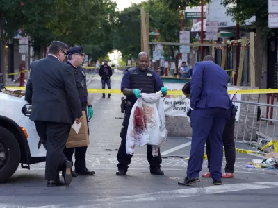 Philadelphia Police investigators work the scene of a fatal overnight shooting on South Street in Philadelphia, Sunday, June 5, 2022. (AP Photo/Michael Perez)