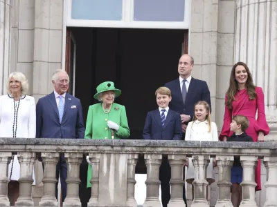 From left, Camilla Duchess of Cornwall, Prince Charles, Queen Elizabeth II, Prince George, Prince William, Princess Charlotte, Prince Louis, and Kate Duchess of Cambridge appear on the balcony of Buckingham Palace during the Platinum Jubilee Pageant outside Buckingham Palace in London, Sunday June 5, 2022, on the last of four days of celebrations to mark the Platinum Jubilee. The pageant will be a carnival procession up The Mall featuring giant puppets and celebrities that will depict key moments from the Queen Elizabeth II's seven decades on the throne. (Ian Vogler/Pool Photo via AP)