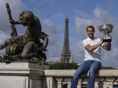 Spain's Rafael Nadal poses with his trophy at Alexander III bridge in Paris, Monday, June 6, 2022, after he won Sunday's men's final match at the French Open tennis tournament in Roland Garros stadium. (AP Photo/Michel Euler)