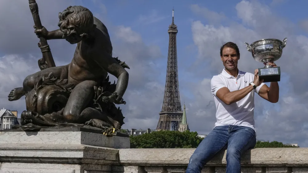 Spain's Rafael Nadal poses with his trophy at Alexander III bridge in Paris, Monday, June 6, 2022, after he won Sunday's men's final match at the French Open tennis tournament in Roland Garros stadium. (AP Photo/Michel Euler)