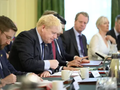 Britain's Prime Minister Boris Johnson, second left, addresses his Cabinet during his weekly Cabinet meeting in Downing Street on Tuesday, June 7, 2022 in London. Johnson was meeting his Cabinet and trying to patch up his tattered authority on Tuesday after surviving a no-confidence vote that has left him a severely weakened leader. (Leon Neal/Pool Photo via AP)