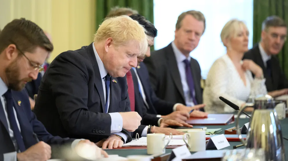 Britain's Prime Minister Boris Johnson, second left, addresses his Cabinet during his weekly Cabinet meeting in Downing Street on Tuesday, June 7, 2022 in London. Johnson was meeting his Cabinet and trying to patch up his tattered authority on Tuesday after surviving a no-confidence vote that has left him a severely weakened leader. (Leon Neal/Pool Photo via AP)