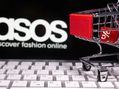 FILE PHOTO: A keyboard and a shopping cart are seen in front of a displayed ASOS logo in this illustration picture taken October 13, 2020. REUTERS/Dado Ruvic/Illustration/File Photo