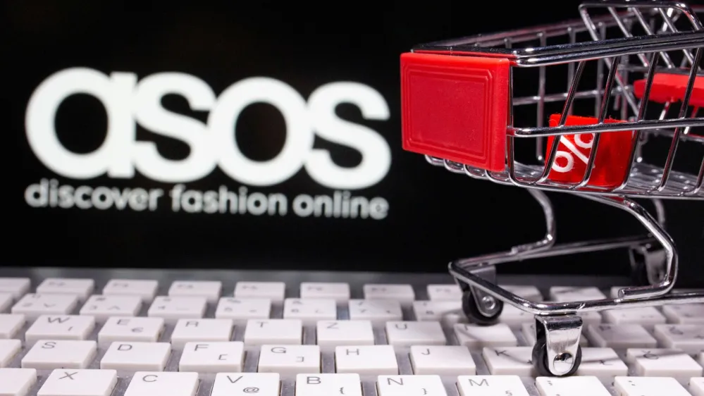 FILE PHOTO: A keyboard and a shopping cart are seen in front of a displayed ASOS logo in this illustration picture taken October 13, 2020. REUTERS/Dado Ruvic/Illustration/File Photo