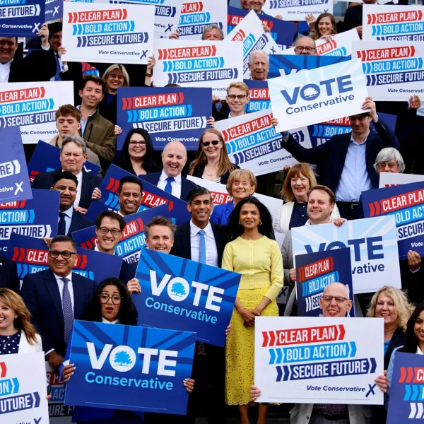 Britain's Prime Minister and Conservative Party leader, Rishi Sunak, and his wife Akshata Murty pose with supporters as Sunak launches the Conservatives' general election manifesto in Silverstone, Britain June 11, 2024.   BENJAMIN CREMEL/Pool via REUTERS