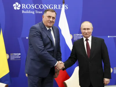 Russian President Vladimir Putin, right, and Bosnian Serb member of the tripartite Bosnian presidency Milorad Dodik pose for a photo prior to their talks on the sidelines of the St. Petersburg International Economic Forum in St. Petersburg, Russia, Saturday, June 18, 2022. (Gavriil Grigorov/TASS Host Photo Agency Pool via AP)