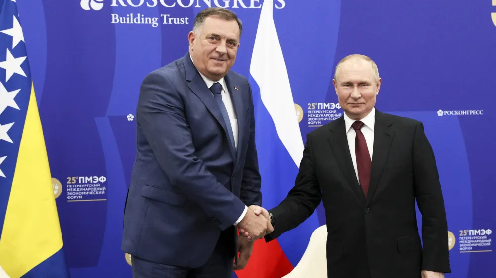 Russian President Vladimir Putin, right, and Bosnian Serb member of the tripartite Bosnian presidency Milorad Dodik pose for a photo prior to their talks on the sidelines of the St. Petersburg International Economic Forum in St. Petersburg, Russia, Saturday, June 18, 2022. (Gavriil Grigorov/TASS Host Photo Agency Pool via AP)