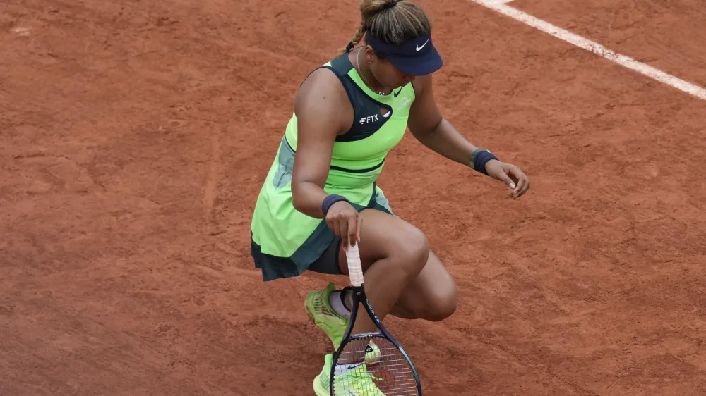 Japan's Naomi Osaka stretches her left foot during her first round match against Amanda Anisimova of the U.S. at the French Open tennis tournament in Roland Garros stadium in Paris, France, Monday, May 23, 2022. (AP Photo/Christophe Ena)