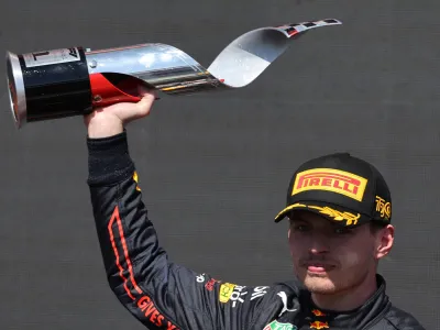 Formula One F1 - Canadian Grand Prix - Circuit Gilles Villeneuve, Montreal, Canada - June 19, 2022 Red Bull's Max Verstappen celebrates with a trophy on the podium after winning the race REUTERS/Chris Helgren