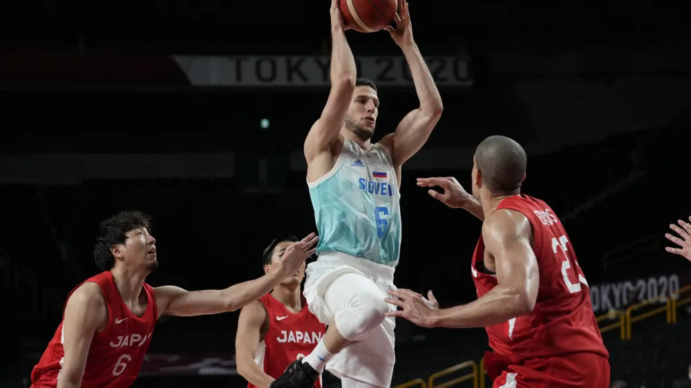 Slovenia's Aleksej Nikolic (6) drives to the basket over Japan's Gavin Earl Edwards (23), right, during men's basketball preliminary round game at the 2020 Summer Olympics, Thursday, July 29, 2021, in Saitama, Japan. (AP Photo/Eric Gay)