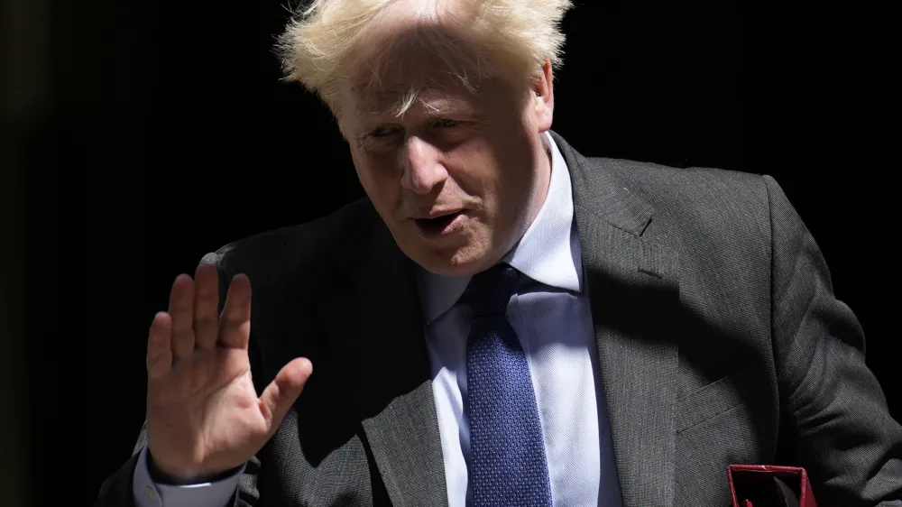 British Prime Minister Boris Johnson waves at the media as he leaves 10 Downing Street, in London, to attend the weekly Prime Minister's Questions at the Houses of Parliament, Wednesday, June 22, 2022. (AP Photo/Matt Dunham)