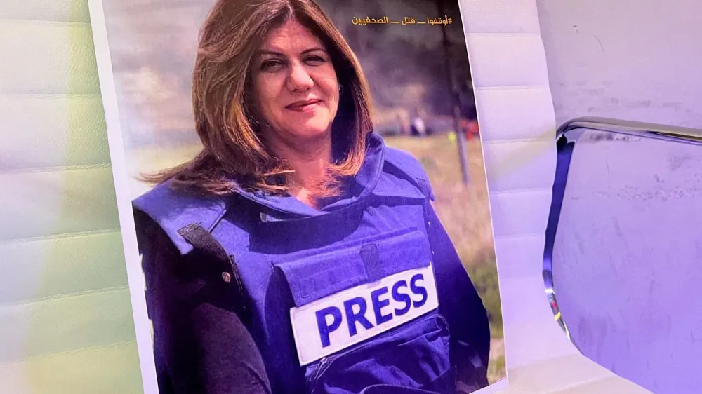 A picture of Al Jazeera reporter Shireen Abu Akleh, who was killed during an Israeli raid in Jenin, is displayed at the Al-Jazeera headquarters building in Doha, Qatar, May 11, 2022. REUTERS/Imad Creidi