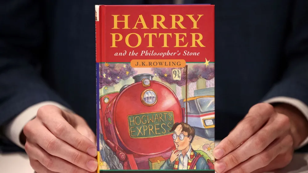 A person holds a rare first edition and signed by the author copy of 'Harry Potter and the Philosophers Stone' by British author J.K. Rowling, which is to be put up for sale at Christie's auction house in London, Britain May 31, 2022. REUTERS/Henry Nicholls