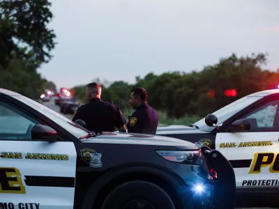 Law enforcement officers work at the scene where people were found dead inside a trailer truck in San Antonio, Texas, U.S. June 27, 2022. REUTERS/Kaylee Greenlee Beal