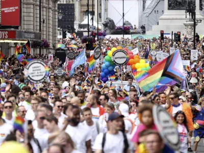 People take part in the Pride rally in London, Saturday July 2, 2022. The U.K. capital marked 50 years of Pride as a vibrant crowd of hundreds of thousands turned out to either take part in or watch the festivities, forming a spectacle of rainbow flags, glitter and sequins. After two years of cancellations because of the coronavirus pandemic, the parade came a half-century after London's first march to celebrate Pride in 1972. (James Manning/PA via AP)