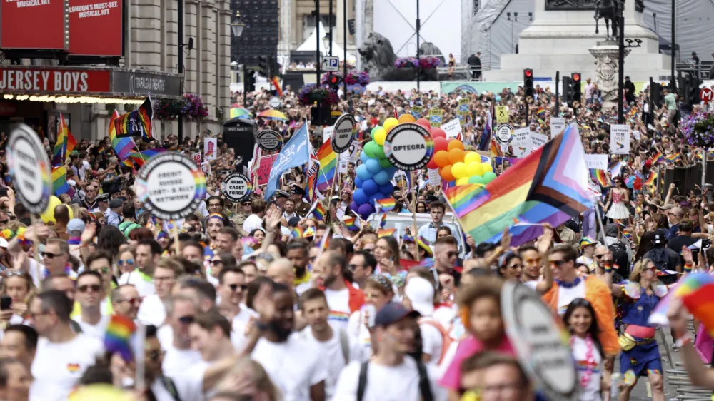 People take part in the Pride rally in London, Saturday July 2, 2022. The U.K. capital marked 50 years of Pride as a vibrant crowd of hundreds of thousands turned out to either take part in or watch the festivities, forming a spectacle of rainbow flags, glitter and sequins. After two years of cancellations because of the coronavirus pandemic, the parade came a half-century after London's first march to celebrate Pride in 1972. (James Manning/PA via AP)