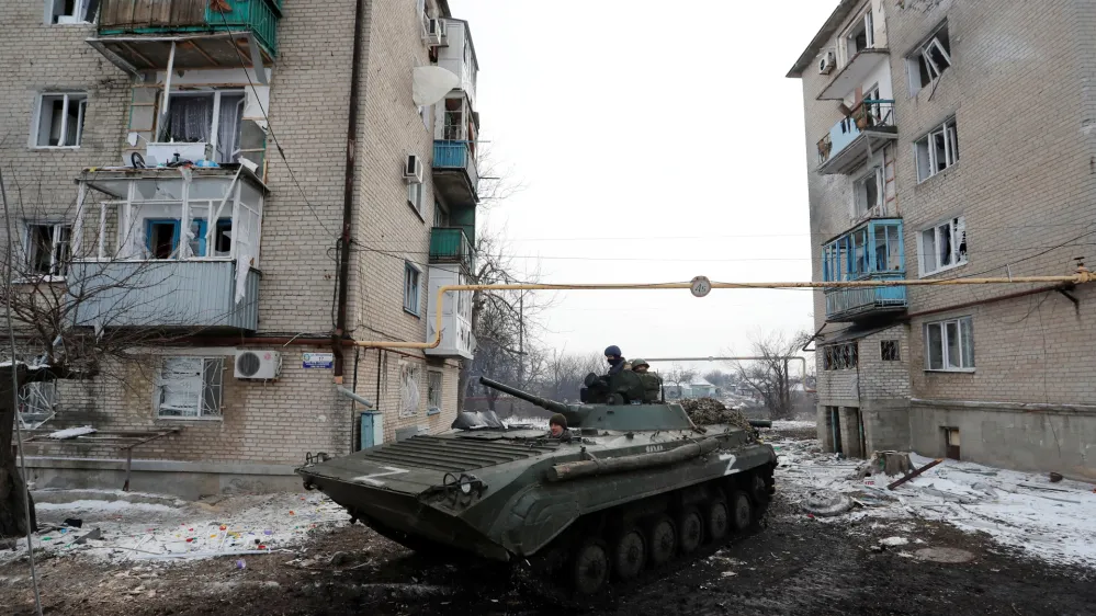 Service members of pro-Russian troops in uniforms without insignia drive an armoured vehicle with the letters "Z" painted on it in a residential area of the separatist-controlled town of Volnovakha during Ukraine-Russia conflict in the Donetsk region, Ukraine March 11, 2022. REUTERS/Alexander Ermochenko