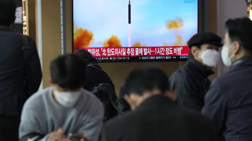 People watch a TV showing a file image of North Korea's missile launch during a news program at the Seoul Railway Station in Seoul, South Korea, Thursday, March 24, 2022. North Korea fired at least one suspected ballistic missile toward the sea Thursday, its neighbors' militaries said, apparently extending its barrage of weapons tests that may culminate with a flight of its biggest-yet intercontinental ballistic missile. (AP Photo/Ahn Young-joon)