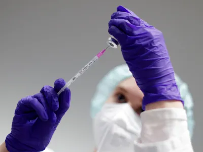 FILE PHOTO: A nurse prepares a shot of Pfizer-BioNTech coronavirus disease (COVID-19) vaccine at the vaccination centre in the Humboldt Forum in Berlin, Germany January 19, 2022. REUTERS/Michele Tantussi/File Photo
