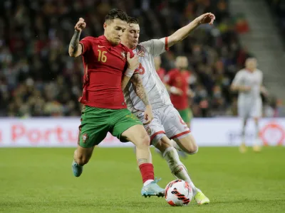 Soccer Football - World Cup - UEFA Qualifiers - Path C Playoff Final - Portugal v North Macedonia - Estadio do Dragao, Porto, Portugal - March 29, 2022 Portugal's Otavio in action with North Macedonia's Ezgjan Alioski REUTERS/Miguel Vidal